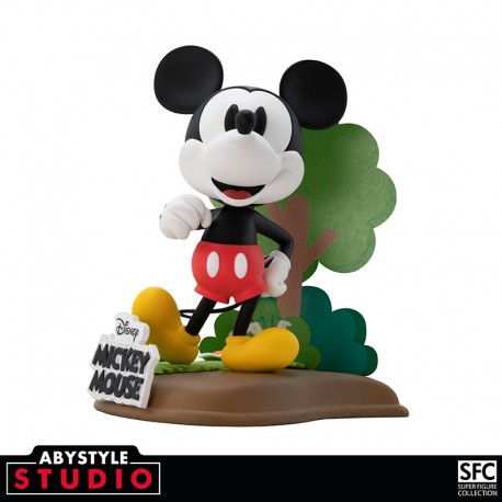 Disney Mickey Mouse Figurine in a standing position with a tree behind him