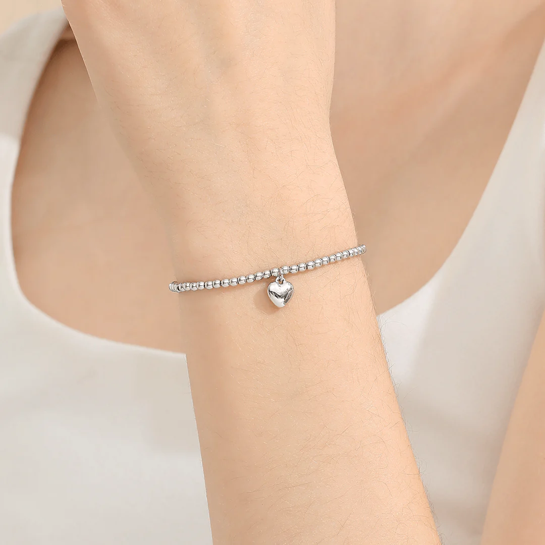 Love You Heart Bracelet worn on wrist, showcasing heart charm and plating