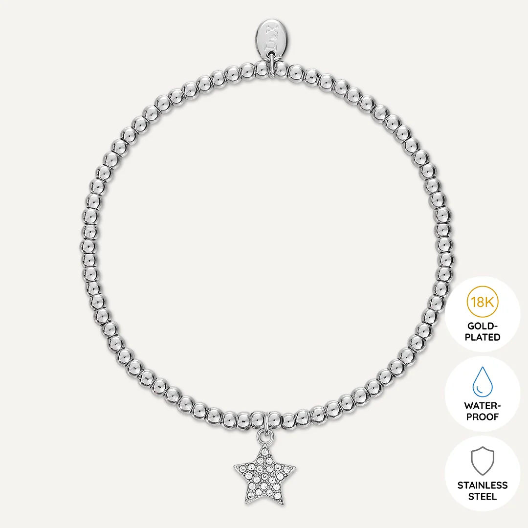 So Proud Of You Bracelet flat-lay on surface with star and beads visible