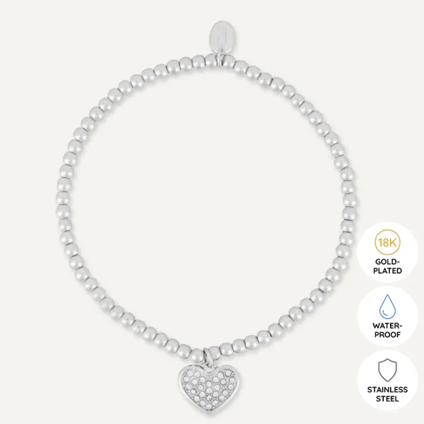Flat lay of You’re Special Heart Bracelet – elegant white gold-plated heart charm bracelet by D&X London